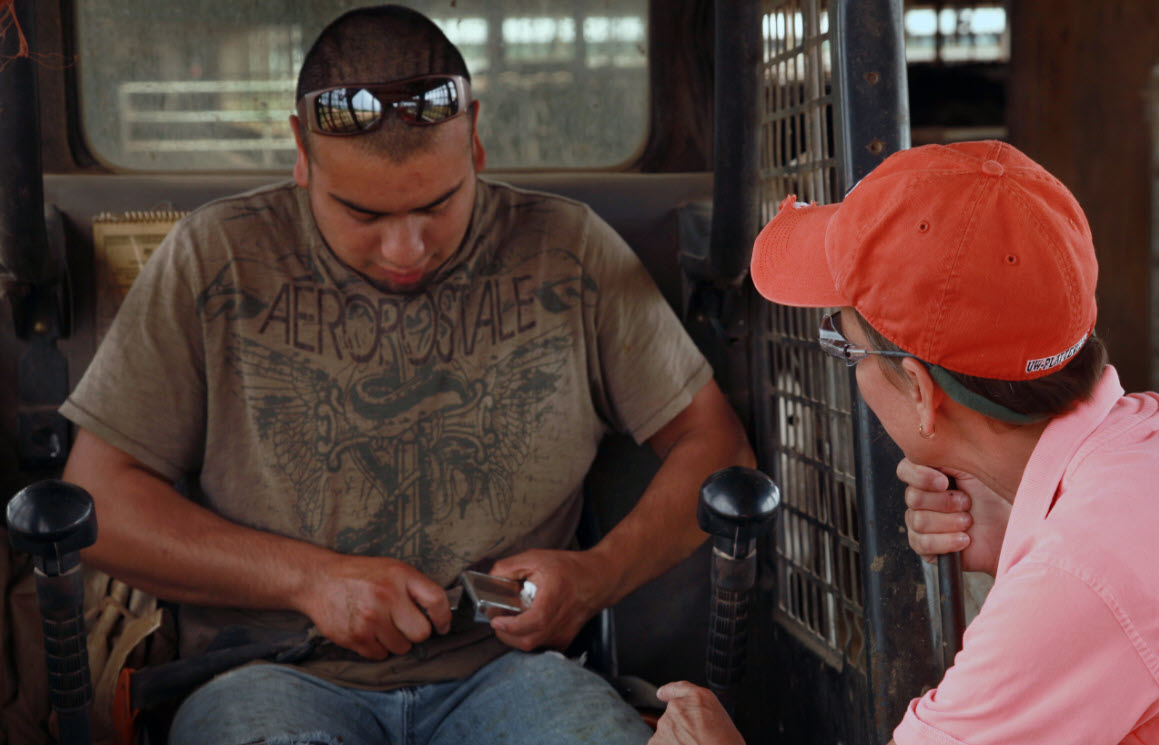 Image of young man being coached by adult